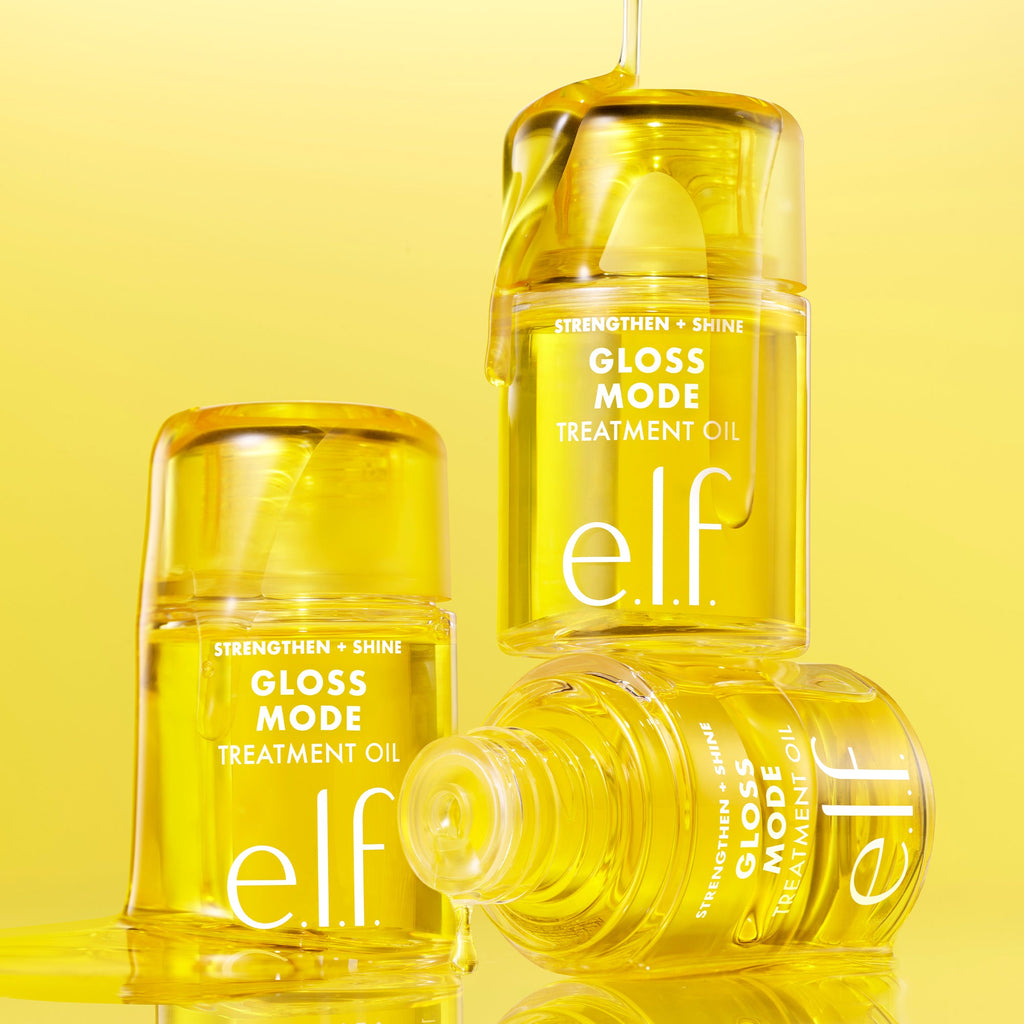 Three bottles of e.l.f. Gloss Mode Treatment Oil on a yellow background